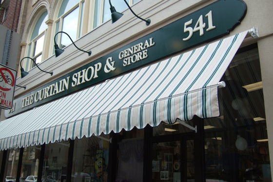retractable awning on the curtain shop & general store front window