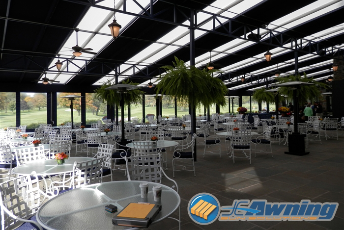 view from the outdoor dining room created by a custom awning and screen system at a golf club